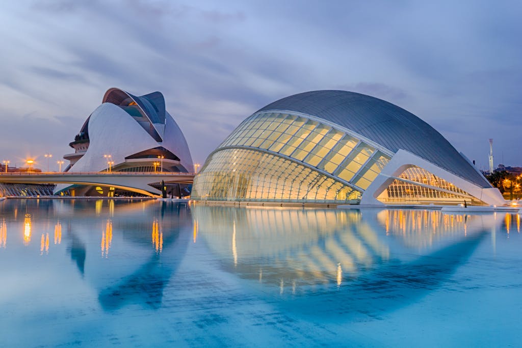 A breathtaking view of Valencia's City of Arts and Sciences reflected in serene waters at twilight.